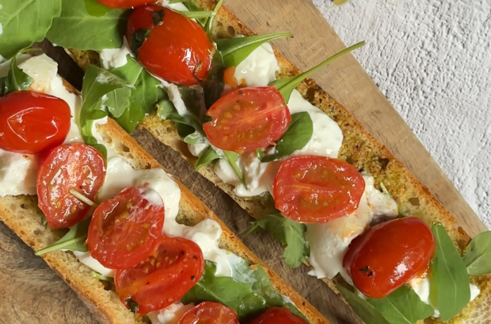 Chrupiąca bagietka z pesto pistacjowym, burratą i grillowanymi pomidorkami